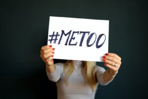 woman holding paper with metoo sign written